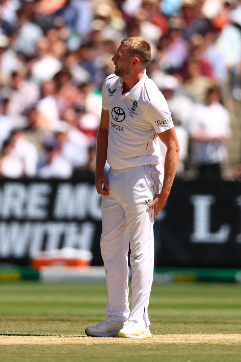 Gus Atkinson reaches for his left hamstring after pulling up short with an injury.