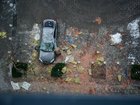 KYIV, UKRAINE - DECEMBER 27: A man looks at his car, parked next to the remains of a Shahed drone, following a Russian air strike