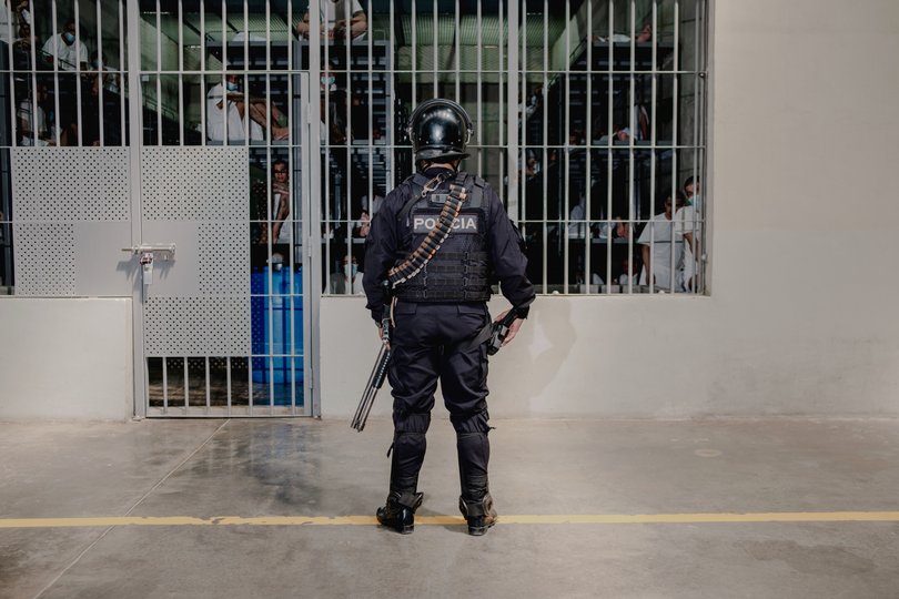 FILE — A guard and prisoners at El Salvador’s Terrorism Confinement Center (CECOT).