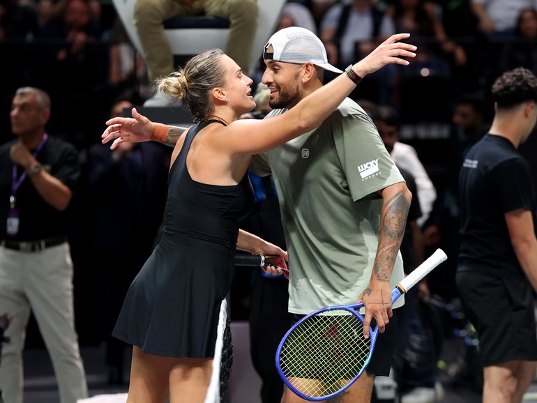 Aryna Sabalenka and Nick Kyrgios embrace at the net after the battle of the sexes match.