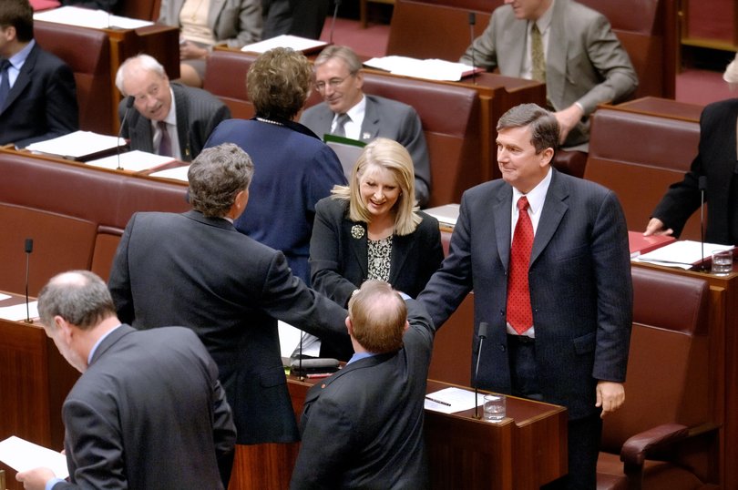Government members, including Senator Helen Coonan, Minister for Communications, Information Technology and the Arts (centre), celebrating the passage of the Telstra sale legislation through the Senate, 14 September 2005.