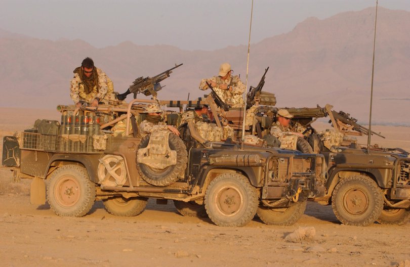 Australian soldiers crewing a Surveillance Reconnaissance Vehicle (SRV) prepare to move at sunrise during a joint Australian and Afghan patrol.
