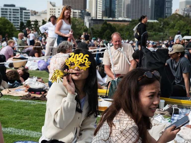 Revellers claimed their spots early ahead of NYE celebrations in Sydney amid heightened security. (Sarah Wilson/AAP PHOTOS)
