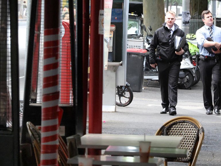 Police at the scene after a group wielding machetes and knives left two men with serious injuries. David Crosling