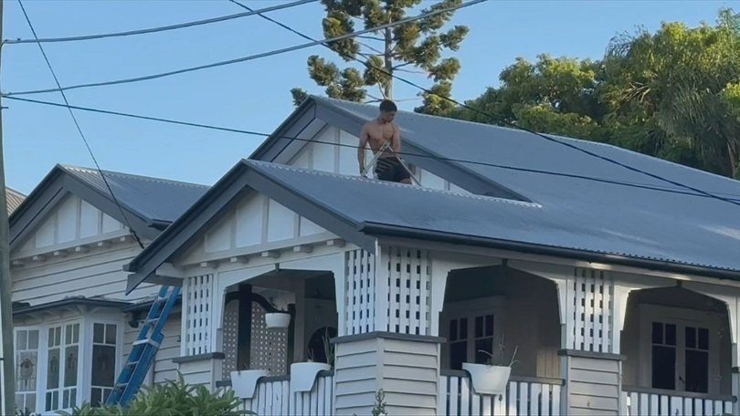 The man was seen ripping a TV antenna off the roof during the hour-long standoff.