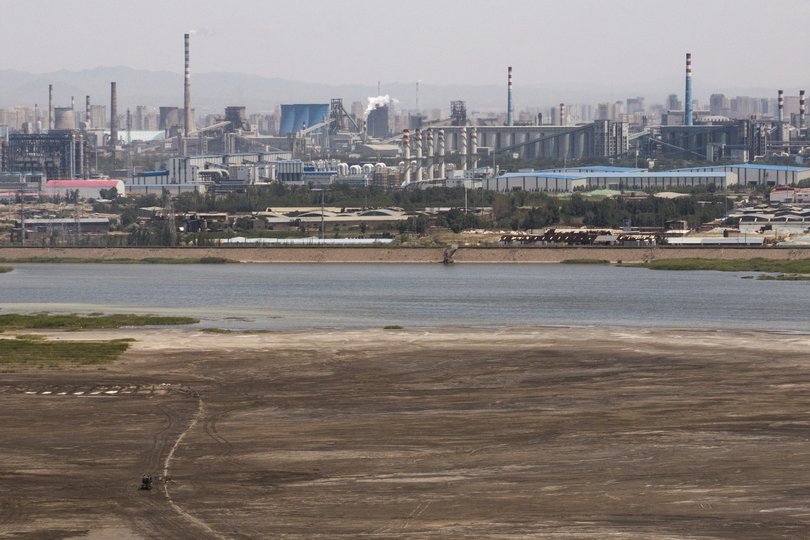 FILE — A lake where contaminates from rare earth and iron ore processing had entered the body of water in Baotou, China, June 9, 2025. Concrete walls were built around the lake to contain it, and former residents nearby had been relocated to safer locations elsewhere. (The New York Times)