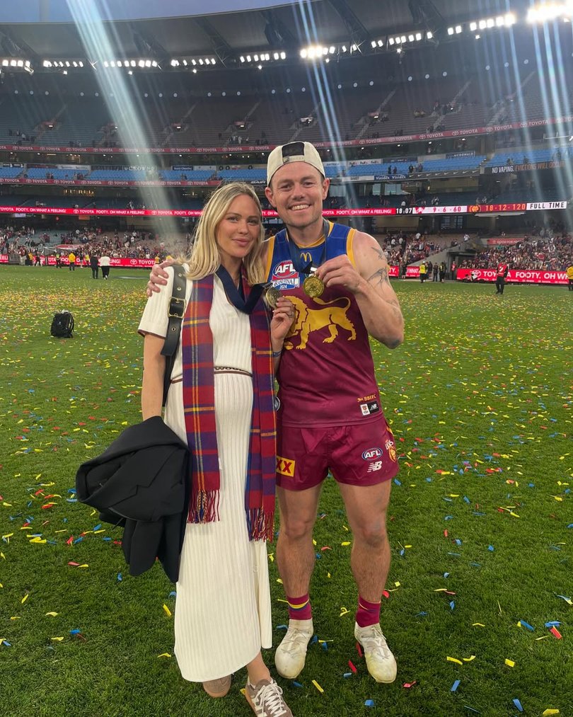 Jules Neale and Lachie Neale celebrate the Lion's premiership win in September.