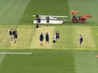 Australian officials inspect the SCG wicket ahead of a final call on selection.
