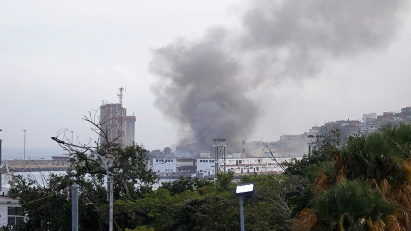 Smoke rises from Port of La Guaira after explosions and low-flying aircraft were heard on Saturday in Caracas.