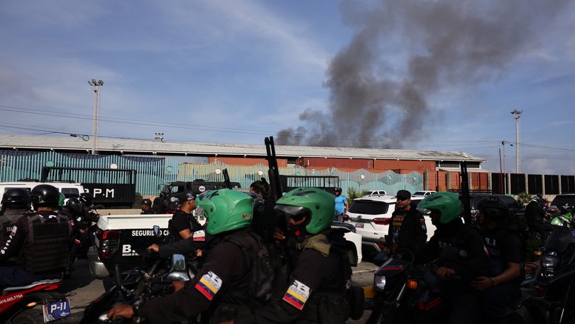 Members of Cuadrantes De La Paz patrol the surroundings of the Port of La Guaira after the explosions.