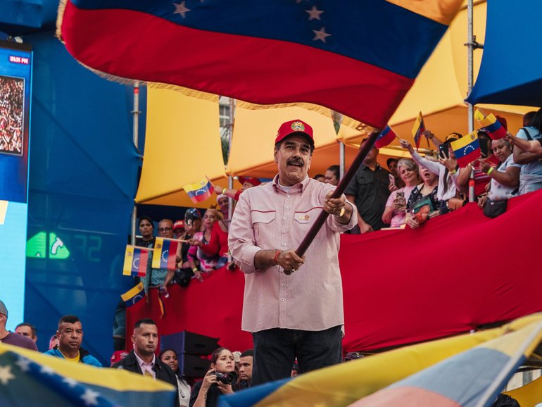 FILE — Venezuela’s autocratic ruler Nicolás Maduro waves the country’s flag during a rally in Caracas, Venezuela, Dec. 1, 2025. 