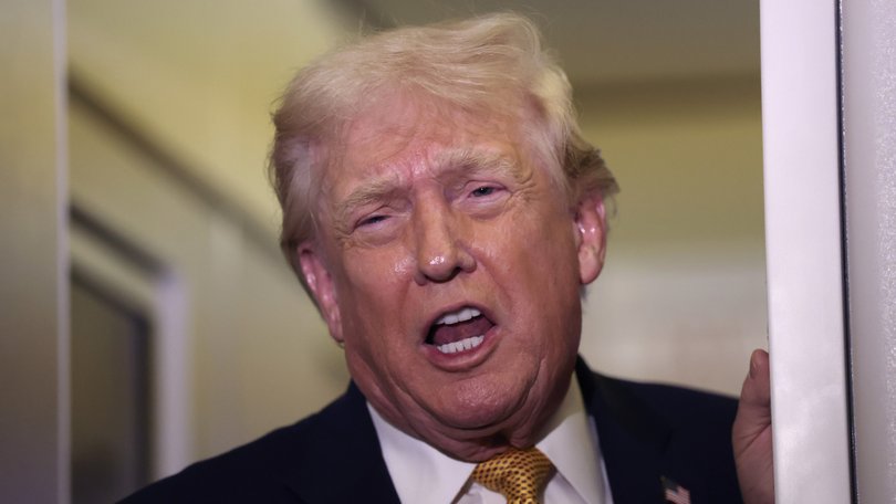 US President Donald Trump speaks aboard Air Force One en route to Washington, DC on January 04, 2026.