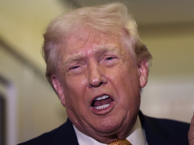 US President Donald Trump speaks aboard Air Force One en route to Washington, DC on January 04, 2026. 