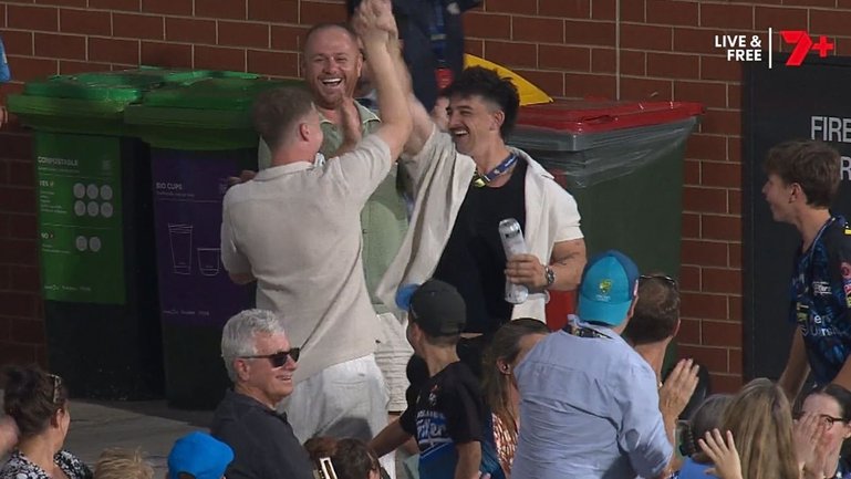 A BBL fan has taken a classic crowd catch while carrying two beer cans. 