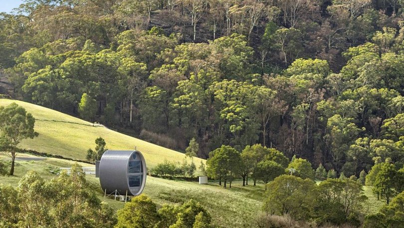 The curved timber villa was designed by local architect Robin Larsen.