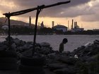 A child walks by the beach at dusk in the outskirts of 'El Palito' refinery on December 18, 2025 in Puerto Cabello, Venezuela. 
