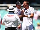 Brydon Carse of England has words with umpire Ahsan Raza after a video review was overruled. 