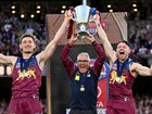 HarrisAndrews, coach Chris Fagan and LachieNeale hold the 2025 AFL premiership cup. (James Ross/AAP PHOTOS)