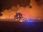 A town has been ripped apart by flames and three people remain unaccounted for as out-of-control bushfires tear through parts of Victoria.