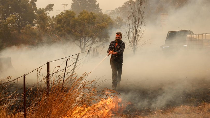 Ross puts out a spot fire. 9th January Friday. Farmers and locals work to defend property near Yarck. The out of control Longwood bushfire has worsened and is now threatening more communities to the south. Jason Edwards