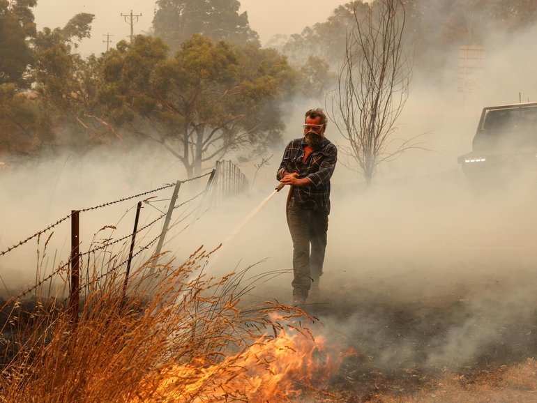 Ross puts out a spot fire. 9th January Friday. Farmers and locals work to defend property near Yarck. The out of control Longwood bushfire has worsened and is now threatening more communities to the south. Jason Edwards