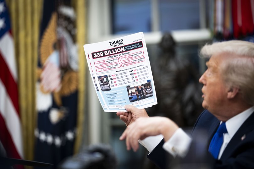 President Donald Trump holds up a visual aid highlighting his popularity on TikTok.