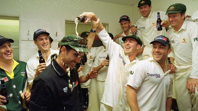 Australia celebrate in the dressing room after winning the fourth day of the England versus Australia first test match at Edgbaston, Birmingham. Justin Langer is covered in beer by replacement Damien Martyn. 
