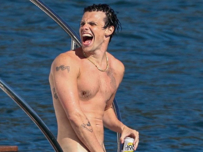 It was very much suns out, buns out on Sydney Harbour, with the British rock star spotted stripping off during a raucous harbour yacht party.