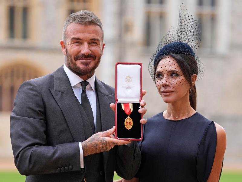 David Beckham and wife Victoria Beckham after the soccer star was knighted. (AP PHOTO)
