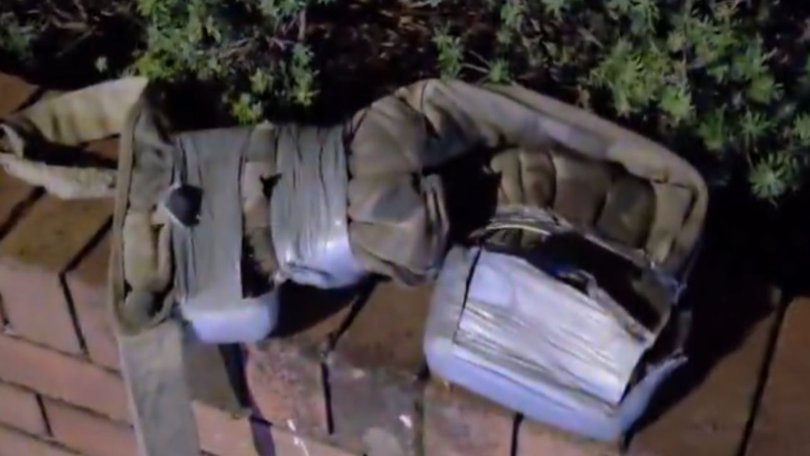 The man was wearing a vest covered in duct taped objects.