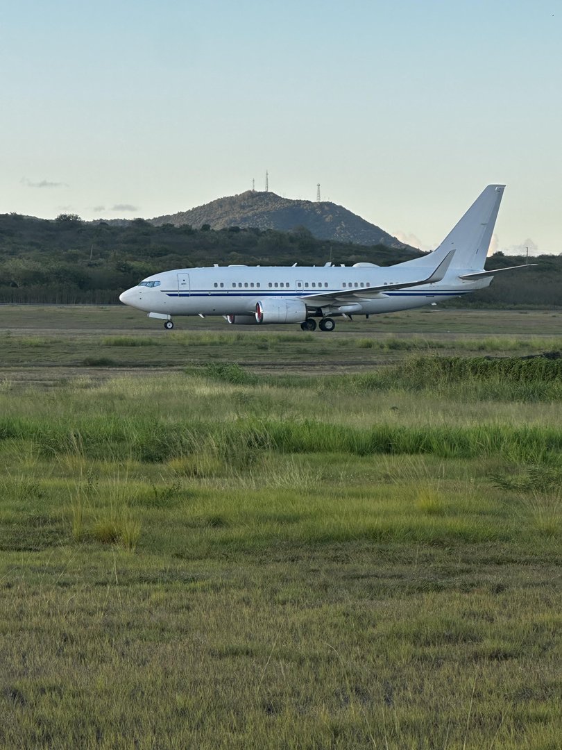 The military modified 737 with no tail markings at St Croix Airport.