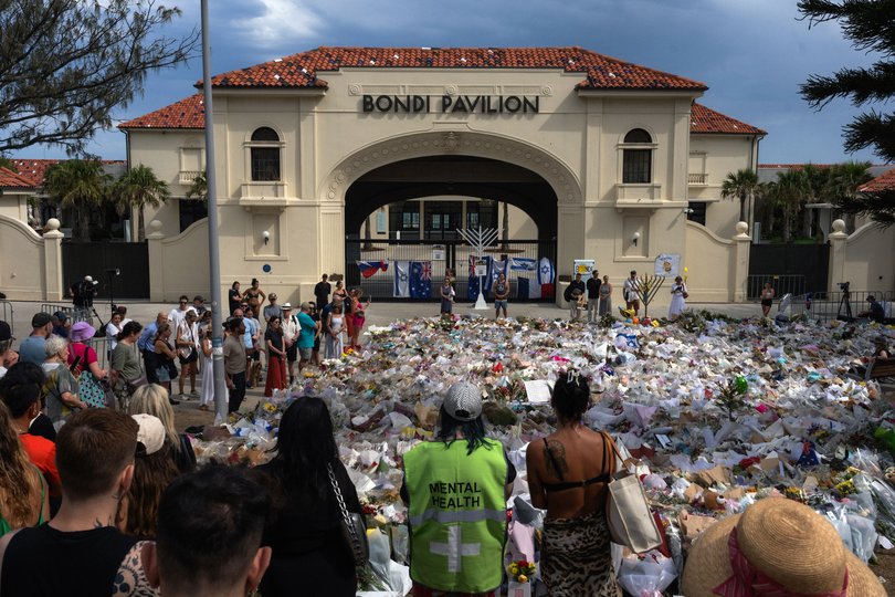 FILE — Mourners gaze out over the sea of flowers left in memory of the victims of the Bondi Beach mass shootng in Sydney, Australia on Dec. 19, 2025. Fifteen people were killed in the Bondi Beach shooting. (Matthew Abbott/The New York Times)