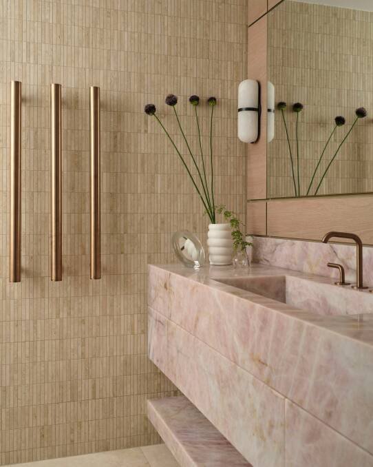 The bathroom features a pink quartz vanity paired with bronze tapware. Pic: Dave Wheeler.
