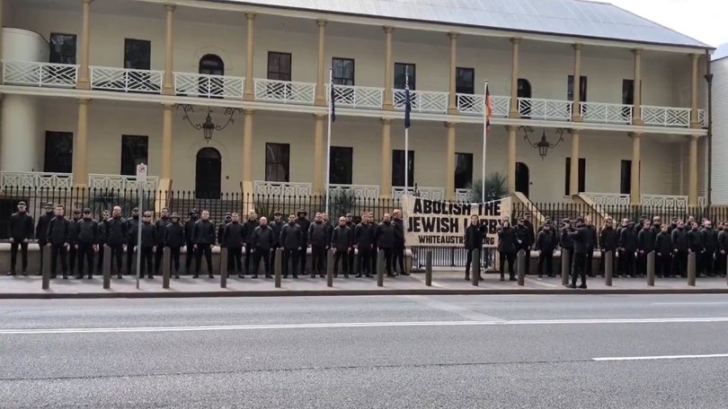 The National Socialist Network protesting outside NSW Parliament in Sydney with a banner saying "Abolish the Jewish lobby".