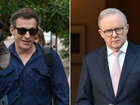 Greg Tait (left) reacted with sarcasm after facing court accused of threatening to kill Prime Minister Anthony Albanese. 