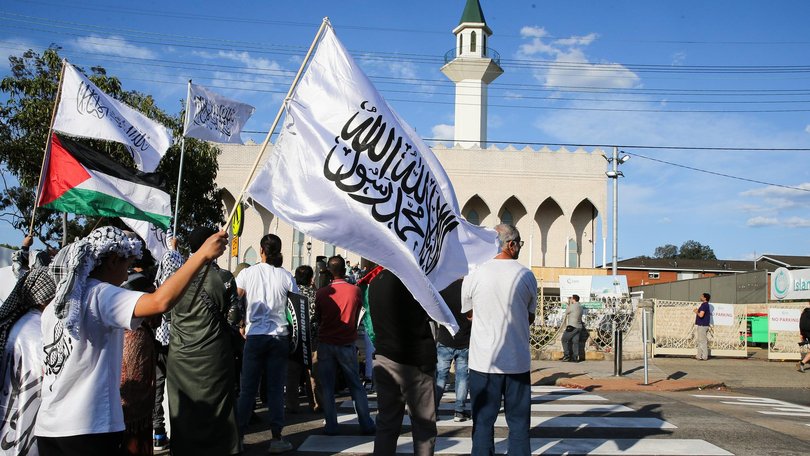 A Hizb ut-Tahrir flag is waved at rally in support of Palestine at Lakemba mosque on the anniversary of October 7.