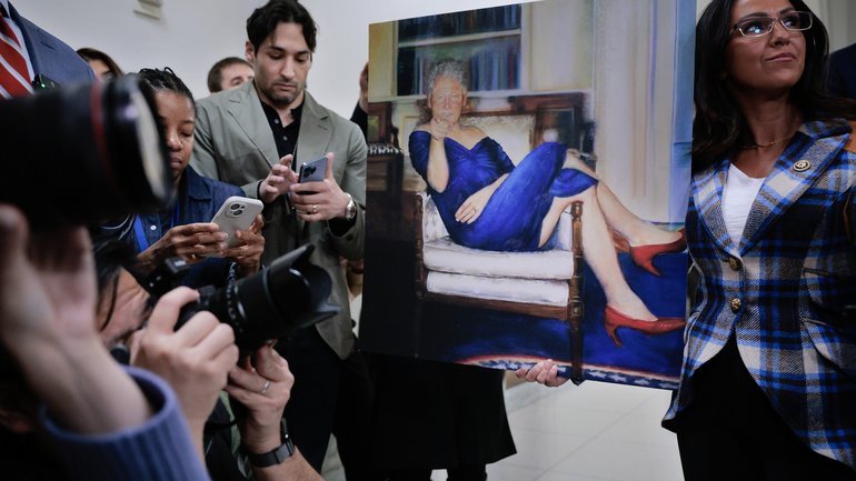 House Oversight and Government Reform Committee member Lauren Boebert, right, holds a copy of Petrina Ryan‑Kleid's painting Parsing Bill, which was allegedly displayed in deceased child sex offender and financier Jeffrey Epstein's home.