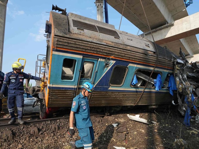 A crane that was being used to build an elevated high-speed railway fell onto a train in Thailand. (AP PHOTO)