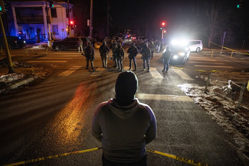 Federal agents face off with protesters in a neighborhood after a federal agent shot a man from Venezuela while attempting to detain him in Minneapolis, Jan. 14, 2026. (David Guttenfelder/The New York Times)