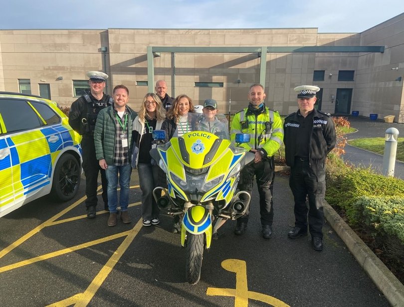 Zac Howells with his mother Nicola Crump and officers with West Mercia police.
