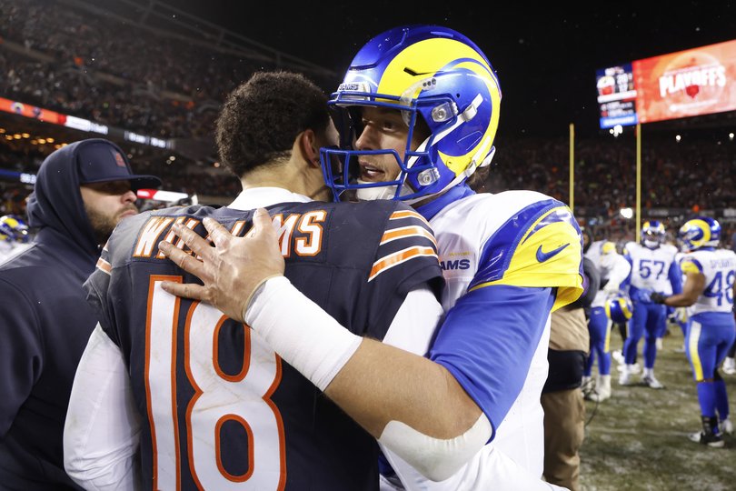 Caleb Williams #18 of the Chicago Bears and Matthew Stafford #9 of the Los Angeles Rams embrace following the NFC Divisional Playoffs game at Soldier Field.