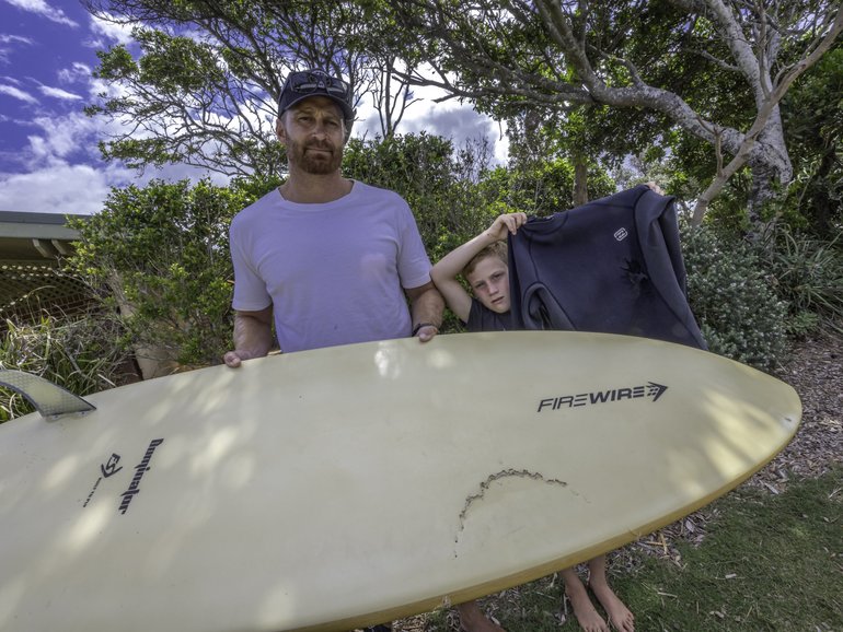 Surfers spotted a group of sharks before one of the ocean predators launched an attack.