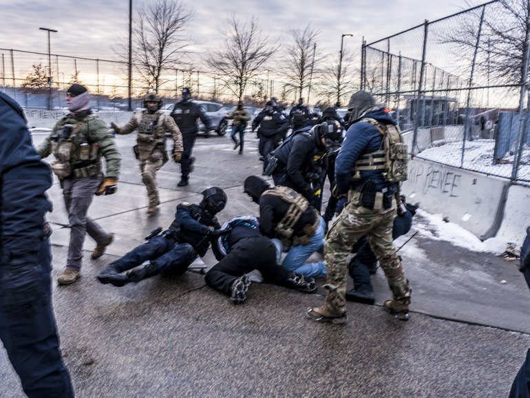 Federal agents detain a demonstrator outside of the Whipple Federal Building in Minneapolis on January 17.