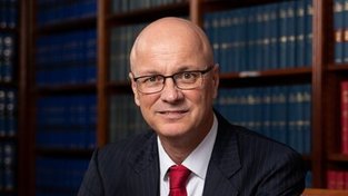 A prominent barrister has been charged after Australian Federal Police allegedly uncovered child abuse material on his phone at Sydney airport.