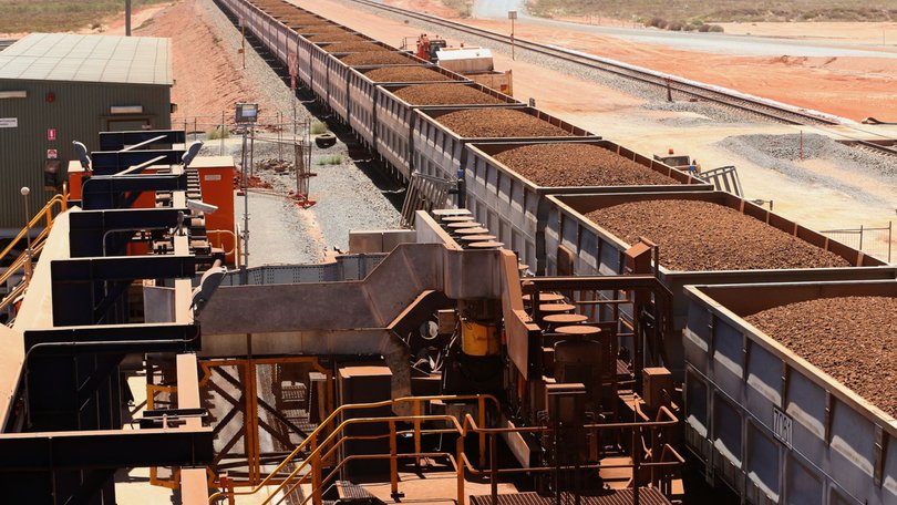 Rail cars laden with iron ore arrive at the receiving facility at Fortescue’s Herb Elliott Port in Port Hedland.