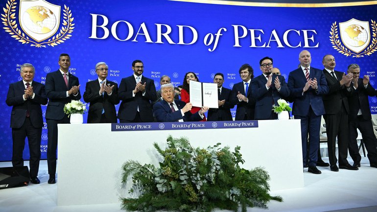 A number of world leaders applaud as US President Donald Trump, centre, holds a signing founding charter at the "Board of Peace" meeting during the World Economic Forum (WEF) annual meeting in Davos on January 22, 2026.. 