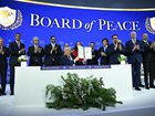 A number of world leaders applaud as US President Donald Trump, centre, holds a signing founding charter at the "Board of Peace" meeting during the World Economic Forum (WEF) annual meeting in Davos on January 22, 2026.. 