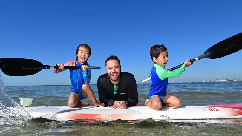 Estelle Pedrara, 6, Anthony Pedrara and Leo Pedrara, 5, at Port Melbourne dog beach took to the water to keep cool. Picture: Josie Hayden