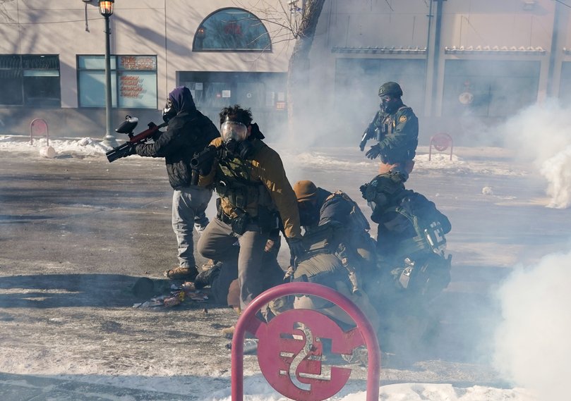 Federal officers detain a protester during a confrontation following the fatal shooting.