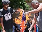 An Australian flag is burned in Brisbane, left, while March for Australia rallies are also held in capital cities.